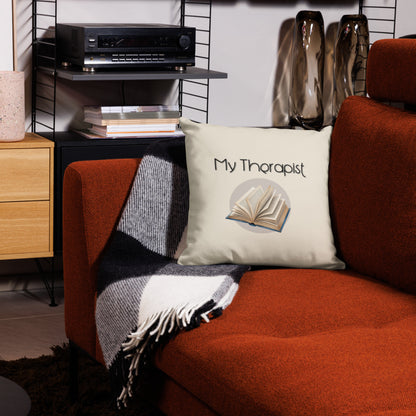 Cream therapy book premium pillow on orange couch with reading books and magazines